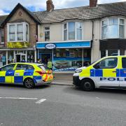 Shop cordoned off in armed police probe