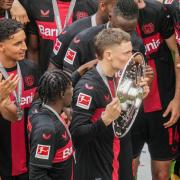 Bayer Leverkusen midfielder Florian Wirtz kisses the Bundesliga trophy after a 2-1 win over Augsburg (Michael Probst/AP/PA)