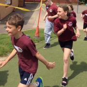 Children running round the school field