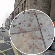Woman taken to hospital with cut to neck following alleged assault. Inset: Blood on pavement