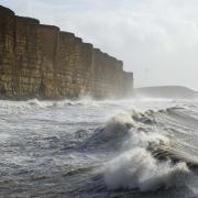 Waves crash in at West Bay by Finnbarr Webster