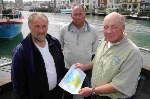 STOPPED FROM WORKING: Andy Alcock, Hugh Cox and David Pitman with a map showing the restricted areas of the sea