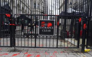Fake blood poured over the gates of Downing Street