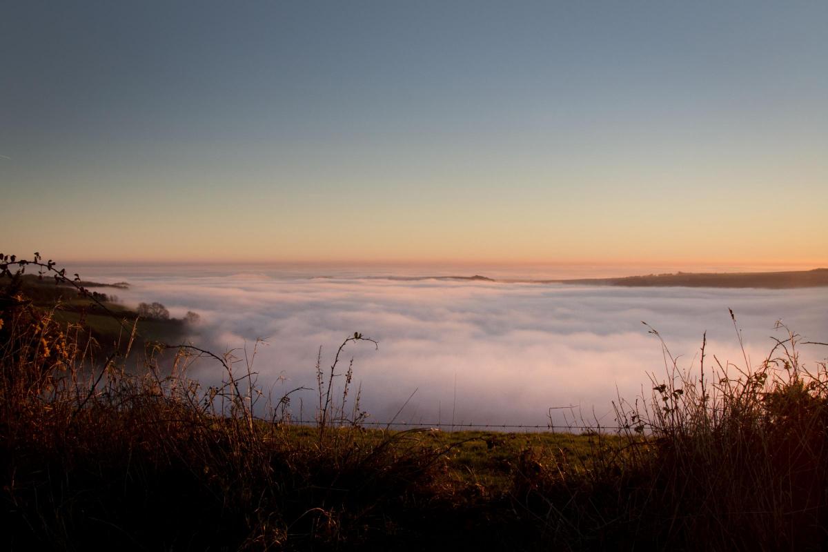 Sunset view overlooking Ansty and Melcombe Bingham viewed from Bullbarrow Hill with the two villages covered in mist, Nov 2016 by Jack Haynes
